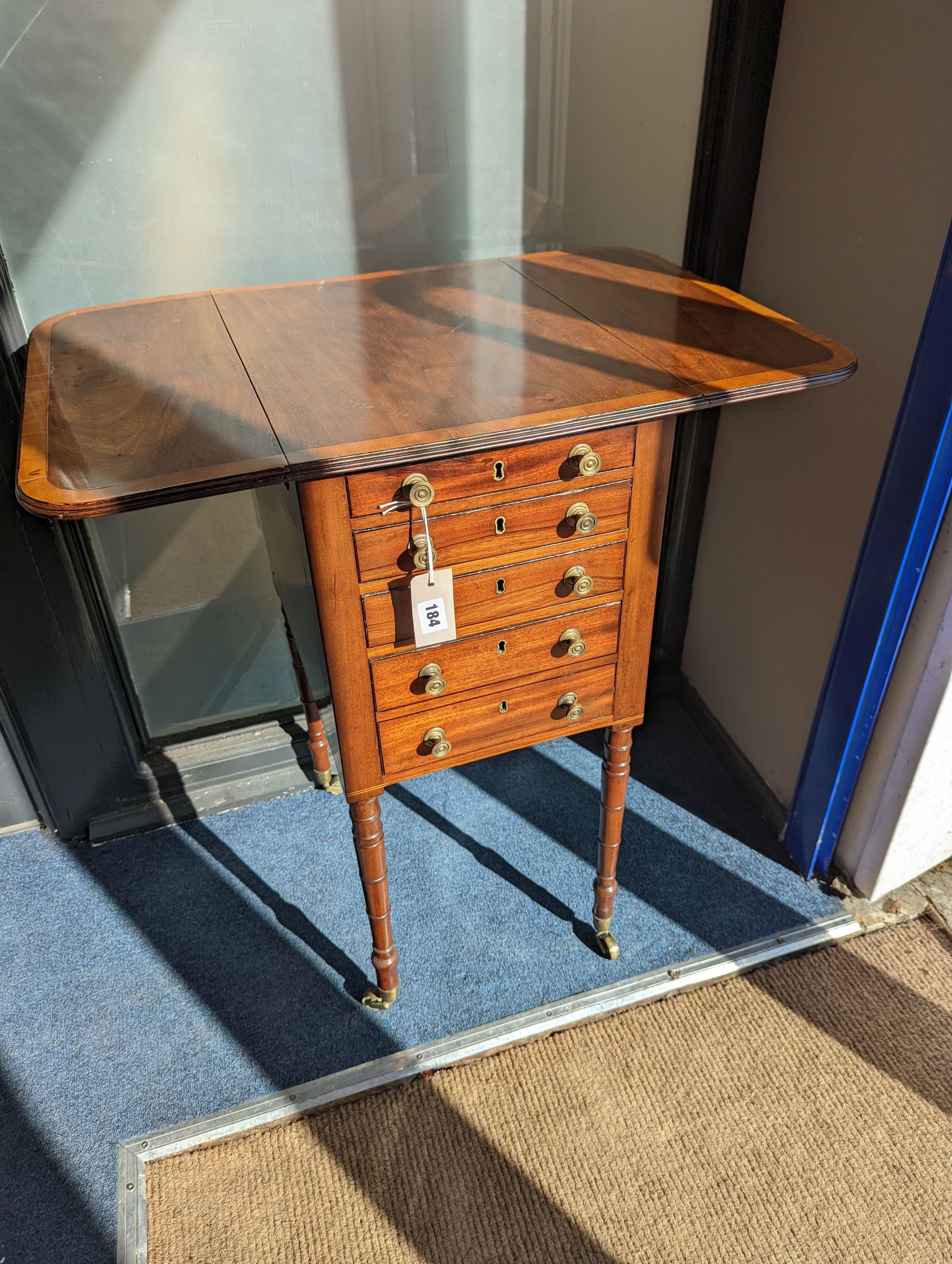 A Regency satinwood banded mahogany drop flap work table, width 69cm extended, depth 46cm, height 76cm